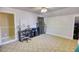Neutral bedroom with patterned carpet with office area, dresser, and access to closet at 4157 Town Branch Ct Sw, Covington, GA 30014
