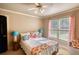 Bright bedroom features a decorative pillows, sunny windows and a cozy atmosphere for relaxation at 4157 Town Branch Ct Sw, Covington, GA 30014