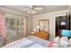 Cozy bedroom features light filled windows and an attractive color scheme, creating a welcoming and comfortable space at 4157 Town Branch Ct Sw, Covington, GA 30014