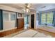 Bright bedroom with hardwood floors, window seat, and access to an ensuite bathroom at 4157 Town Branch Ct Sw, Covington, GA 30014