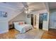 Comfortable bedroom featuring hardwood floors, a ceiling fan, and stylish decor at 4157 Town Branch Ct Sw, Covington, GA 30014
