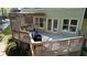 Two-story deck with outdoor seating and grill, plus convenient access to home's interior through French doors at 4157 Town Branch Ct Sw, Covington, GA 30014