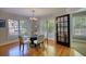 Bright dining room with hardwood floors, a glass table, and large windows at 4157 Town Branch Ct Sw, Covington, GA 30014