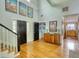 Bright foyer boasts hardwood floors, artful decor, and a grand staircase for a welcoming entrance at 4157 Town Branch Ct Sw, Covington, GA 30014