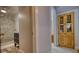 Hallway with views of the marble bathroom and the cabinet for seamless transition between spaces at 4157 Town Branch Ct Sw, Covington, GA 30014