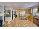 Kitchen with granite countertops and stainless appliances, adjacent to a cozy living area at 4157 Town Branch Ct Sw, Covington, GA 30014