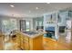 Open kitchen with a granite-topped island and cooktop, adjacent to a dining area and fireplace at 4157 Town Branch Ct Sw, Covington, GA 30014