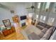 Sun-filled living room with hardwood floors, fireplace, high ceilings, and open concept to the kitchen at 4157 Town Branch Ct Sw, Covington, GA 30014
