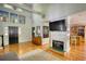 Bright living room boasts a high ceiling, wooden floor, natural light, a fireplace and comfortable gray sofa at 4157 Town Branch Ct Sw, Covington, GA 30014