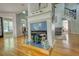 Cozy living room with a fireplace and an open floor plan, offering a view of the staircase at 4157 Town Branch Ct Sw, Covington, GA 30014