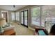 Bright sunroom features large windows, comfortable seating, and access to an outdoor deck at 4157 Town Branch Ct Sw, Covington, GA 30014