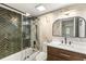 Beautiful bathroom with herringbone tiled shower, elegant marble wall, and modern vanity with sink at 72 Ivy Ne Pkwy, Atlanta, GA 30342