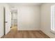 Bright bedroom featuring hardwood floors, white walls, and a large window with plantation shutters at 72 Ivy Ne Pkwy, Atlanta, GA 30342