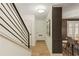 Bright hallway with hardwood floors and railing, leading to the front door at 72 Ivy Ne Pkwy, Atlanta, GA 30342