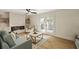 Bright living room with fireplace, built-ins, and glass doors to the patio at 72 Ivy Ne Pkwy, Atlanta, GA 30342