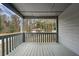 Back porch of a house with grey painted railing and open backyard view at 1545 Orlando Sw St, Atlanta, GA 30311