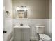 Bathroom with gray vanity, modern fixtures, and white beadboard at 1545 Orlando Sw St, Atlanta, GA 30311