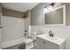 Well-lit bathroom with a shower and tub combination, vanity with storage, and clean finishes at 1545 Orlando Sw St, Atlanta, GA 30311