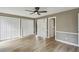 Spacious bedroom featuring hardwood floors, a ceiling fan, and two closets at 1545 Orlando Sw St, Atlanta, GA 30311