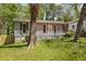 Exterior of home with front porch, covered walkway, and green lawn at 1545 Orlando Sw St, Atlanta, GA 30311