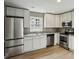 Modern kitchen with stainless steel appliances, granite countertops, and white cabinets at 1545 Orlando Sw St, Atlanta, GA 30311