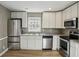 Modern kitchen features granite countertops, stainless steel appliances, and ample cabinet space at 1545 Orlando Sw St, Atlanta, GA 30311