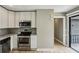 Updated kitchen with stainless steel appliances, white cabinets, and a sliding door to the deck at 1545 Orlando Sw St, Atlanta, GA 30311