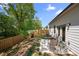 Relaxing backyard with a concrete patio, seating, privacy fence, and landscaped greenery at 2617 Cacao Sq, Acworth, GA 30101