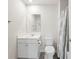 A bathroom featuring a white vanity, toilet, mirror and a shower with a patterned gray curtain at 2617 Cacao Sq, Acworth, GA 30101