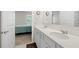 Bathroom featuring a dual vanity with white cabinets and quartz countertops with view to bedroom at 2617 Cacao Sq, Acworth, GA 30101