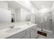 Bright bathroom showcasing a dual vanity, a framed mirror, and a glass-enclosed shower at 2617 Cacao Sq, Acworth, GA 30101