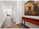 Inviting hallway with hardwood floors and a console table with painting, offering a glimpse into the home's layout at 2617 Cacao Sq, Acworth, GA 30101
