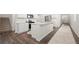 Bright, modern kitchen with white cabinets, stainless steel appliances, and island at 2617 Cacao Sq, Acworth, GA 30101