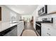 Well-lit kitchen with stainless steel appliances, white cabinets, and view of the dining area at 2617 Cacao Sq, Acworth, GA 30101