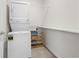 Functional laundry room featuring a stackable washer and dryer, storage shelves, and tile flooring at 2617 Cacao Sq, Acworth, GA 30101