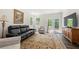 Comfortable living room with plush seating, area rug, and natural light from windows at 2617 Cacao Sq, Acworth, GA 30101