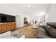 Inviting living room features a plush sofa, media console, rug, and connects to other rooms at 2617 Cacao Sq, Acworth, GA 30101