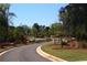 Winding street with landscaped boulevards and mature trees in a residential neighborhood at 2617 Cacao Sq, Acworth, GA 30101