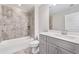 Modern bathroom featuring tiled shower-tub, quartz countertop vanity, and sleek fixtures with contemporary appeal at 3220 Montebello Pkwy, Cumming, GA 30028