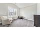 Well-lit room with neutral walls and carpet with a modern accent chair, perfect for relaxation or study at 3220 Montebello Pkwy, Cumming, GA 30028