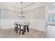 Traditional dining room featuring modern chandelier, hardwood floors, and wainscoting detail at 3220 Montebello Pkwy, Cumming, GA 30028