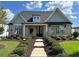 Charming brick home with manicured lawn, symmetrical landscaping, and covered entrance at 3220 Montebello Pkwy, Cumming, GA 30028