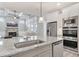 Open concept kitchen featuring granite countertops, stainless appliances, and views of living space at 3220 Montebello Pkwy, Cumming, GA 30028