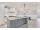 Bright, open kitchen featuring a large island, stainless appliances, and modern pendant lighting at 3220 Montebello Pkwy, Cumming, GA 30028