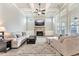 Bright living room boasts a stone fireplace, coffered ceiling, and large windows at 3220 Montebello Pkwy, Cumming, GA 30028
