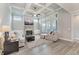 Inviting living room showcases a stone fireplace, coffered ceiling, and an abundance of natural light at 3220 Montebello Pkwy, Cumming, GA 30028