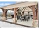 Elegant outdoor lounge area with a fireplace, television, and comfortable seating at 3220 Montebello Pkwy, Cumming, GA 30028