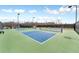 View of the community's pickleball courts with nets and benches under blue skies at 3220 Montebello Pkwy, Cumming, GA 30028