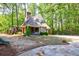 Charming backyard cottage with playground, basketball court, lush greenery, and stone patio at 728 Wesley Nw Dr, Atlanta, GA 30305
