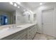 Bright bathroom featuring white double vanity with granite countertop and large mirror and tile floors that add a touch of elegance at 728 Wesley Nw Dr, Atlanta, GA 30305